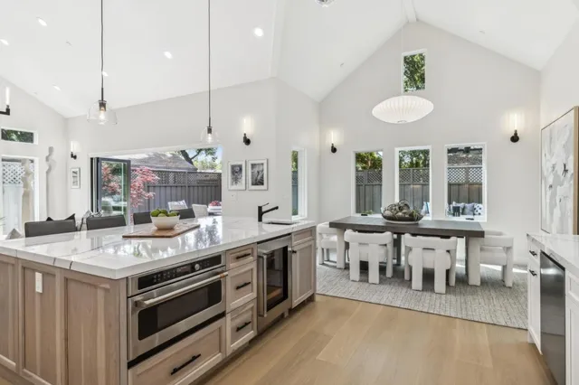 a kitchen with a stove and white cabinets