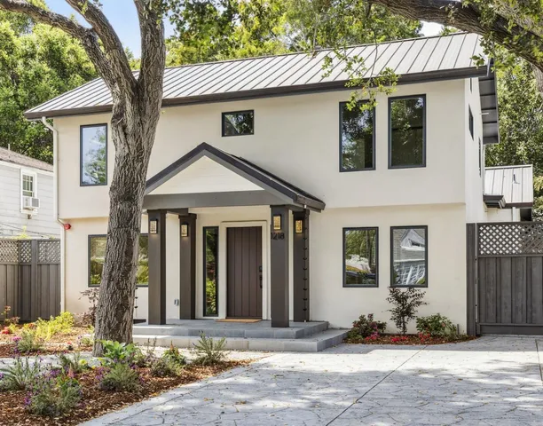 a front view of a house with a yard and outdoor seating