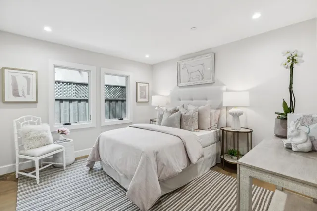 a bedroom with a bed a table and chair