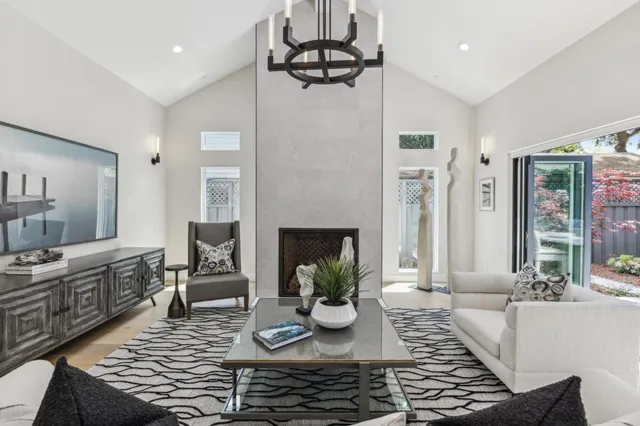 a living room with furniture kitchen and a chandelier