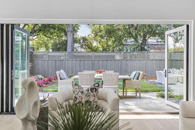 a large kitchen with kitchen island a table and chairs in it