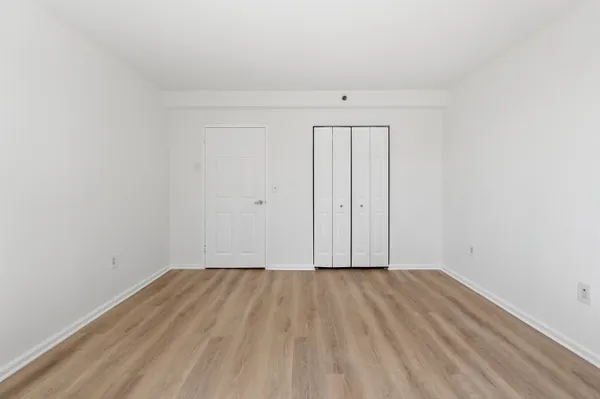 a view of room with wooden floor