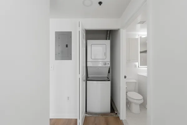 a bathroom with a granite countertop toilet and a shower