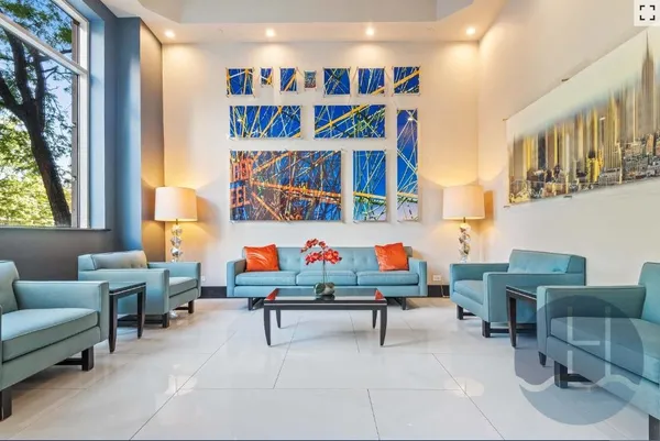 a living room with furniture and a book shelf