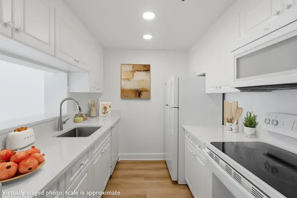 a kitchen with granite countertop a sink and a stove top oven