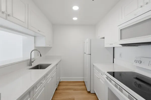 a kitchen with a sink and a refrigerator