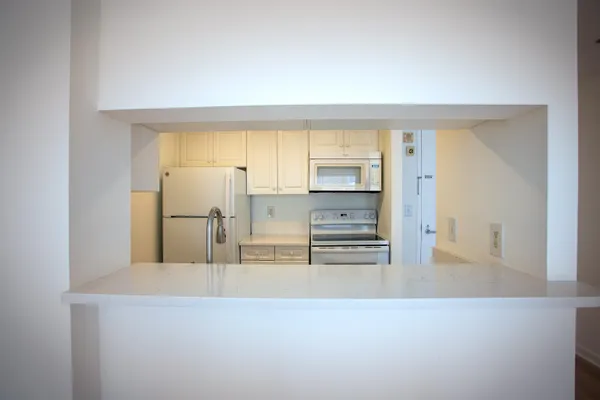 a kitchen with cabinets and a refrigerator