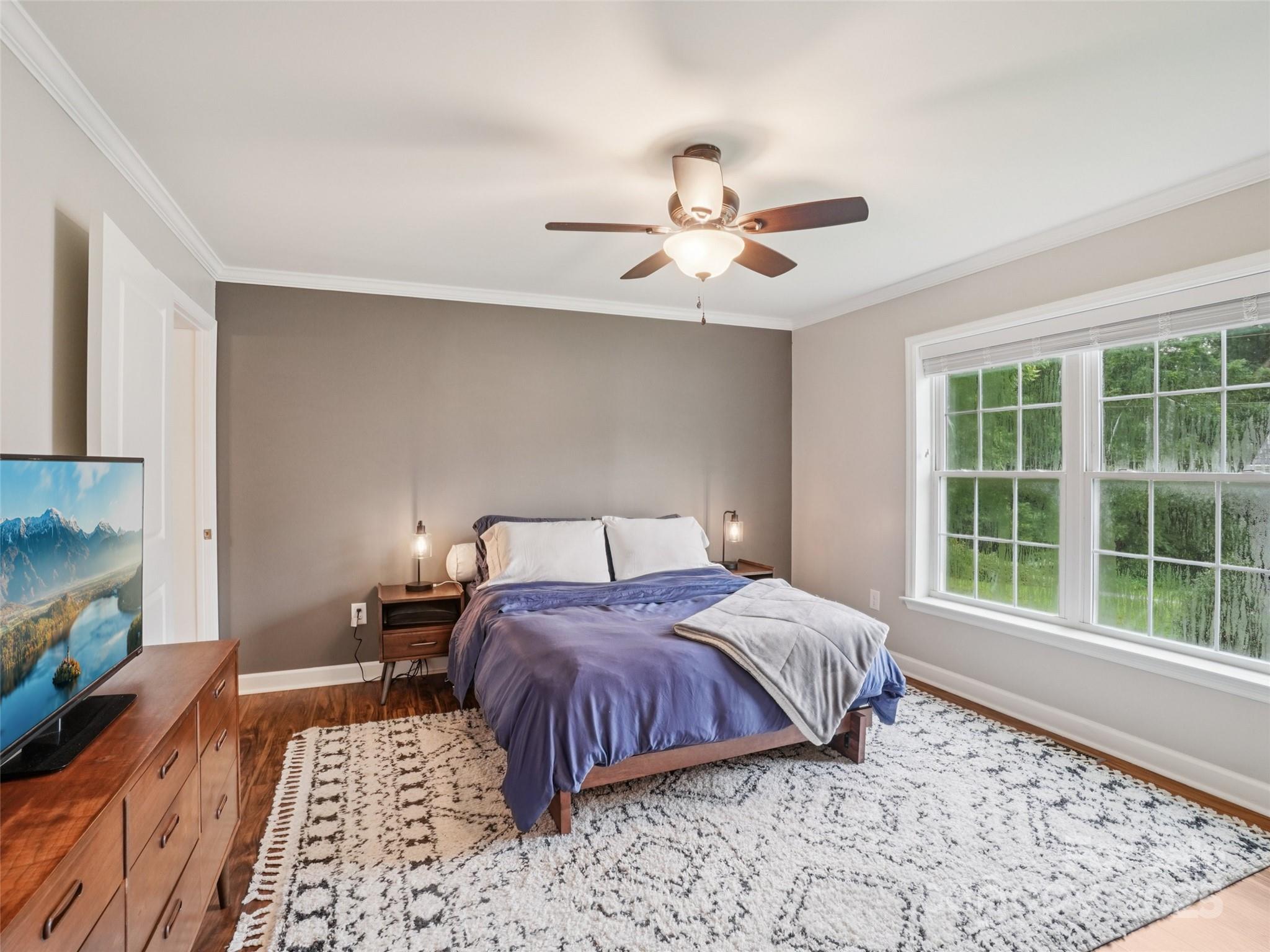 32 Lewis Street Canton, NC 28716 - Photo 15 of 27 a bedroom with a bed ceiling fan and a window
