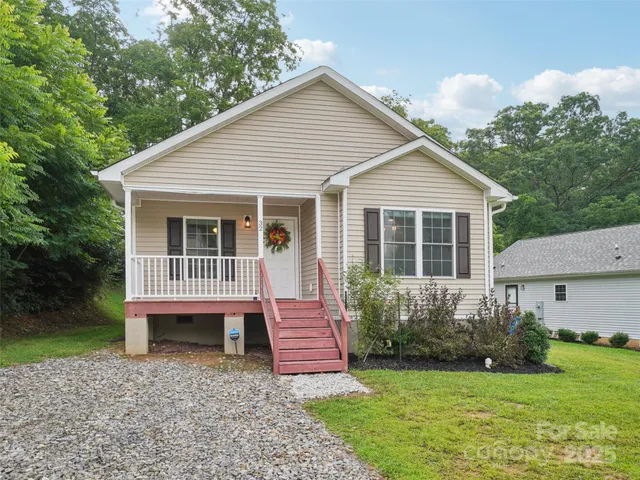 a view of a house with a yard and a garden