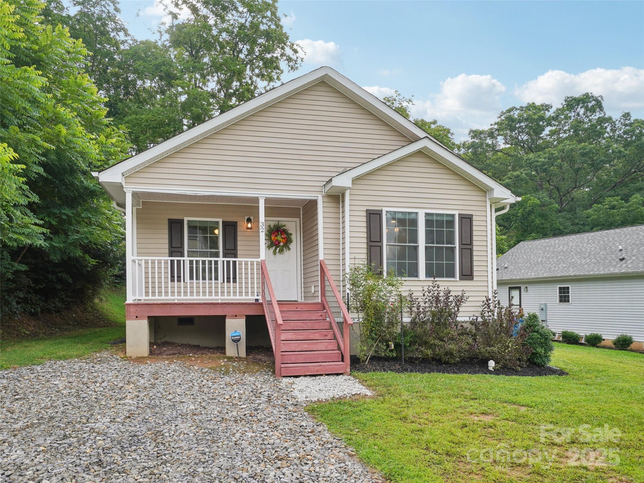 32 Lewis Street Canton, NC 28716 - Photo 21 of 27 a view of a house with a yard and a garden