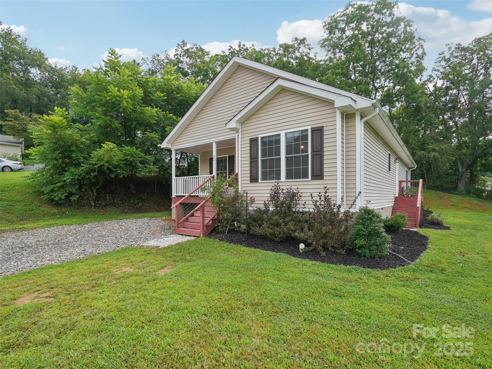 32 Lewis Street Canton, NC 28716 - Photo 22 of 27 a view of a house with a yard and potted plants