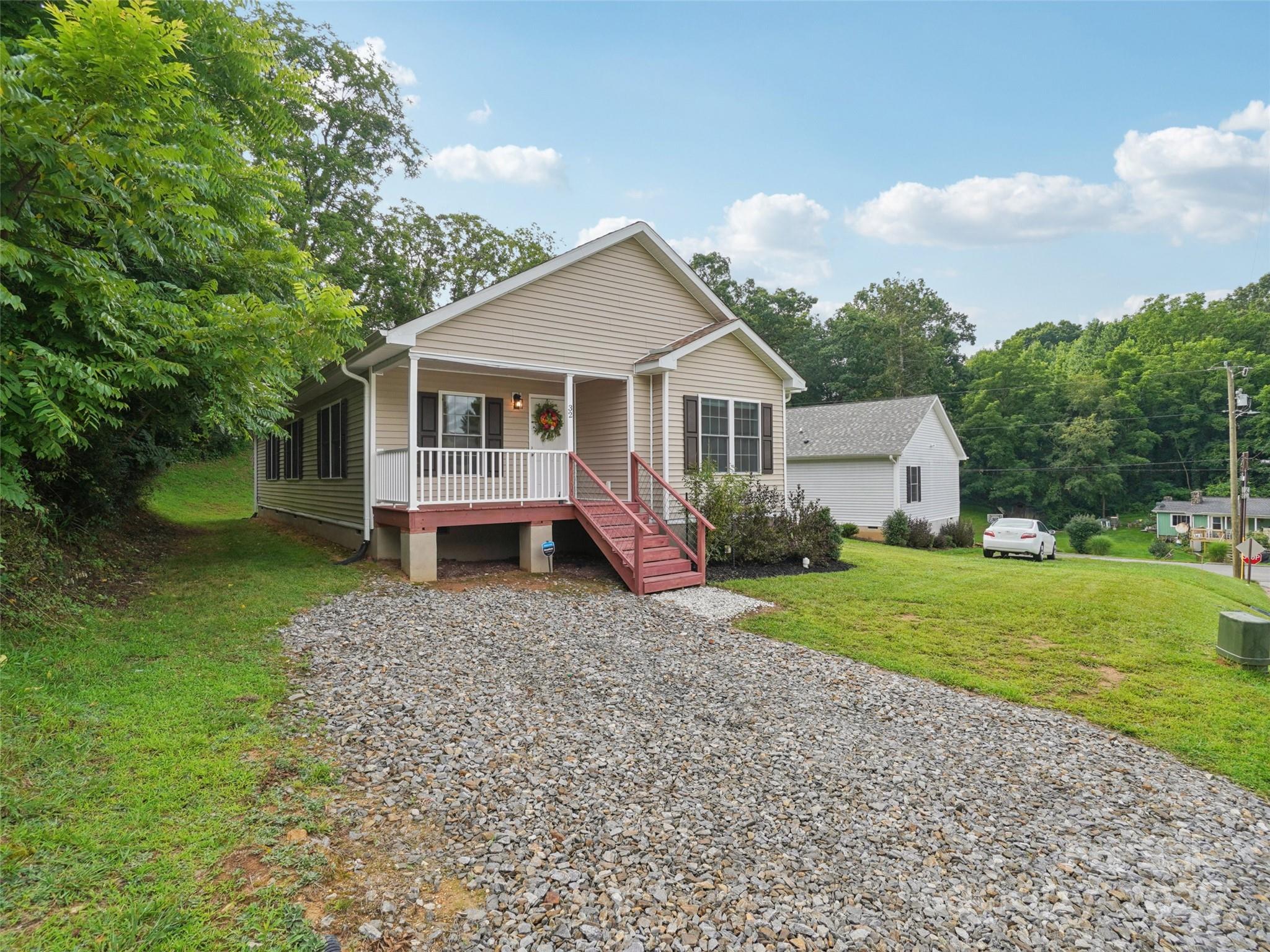 32 Lewis Street Canton, NC 28716 - Photo 24 of 27 a view of a house with yard and a garden
