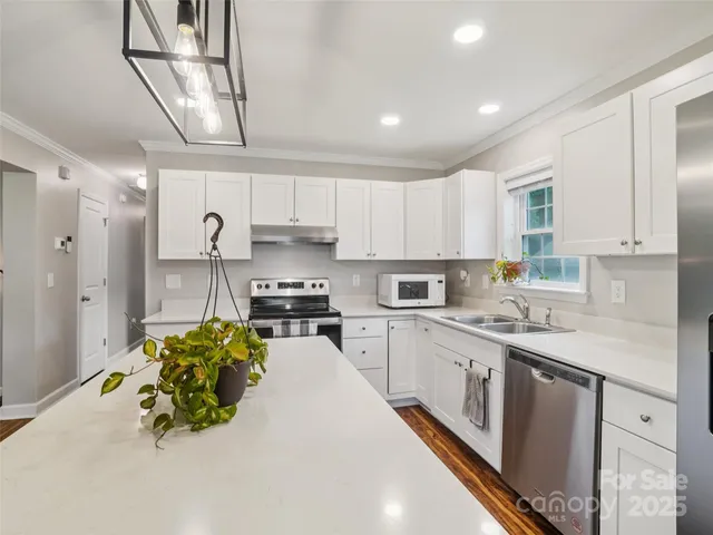 a kitchen with a sink a stove and cabinets
