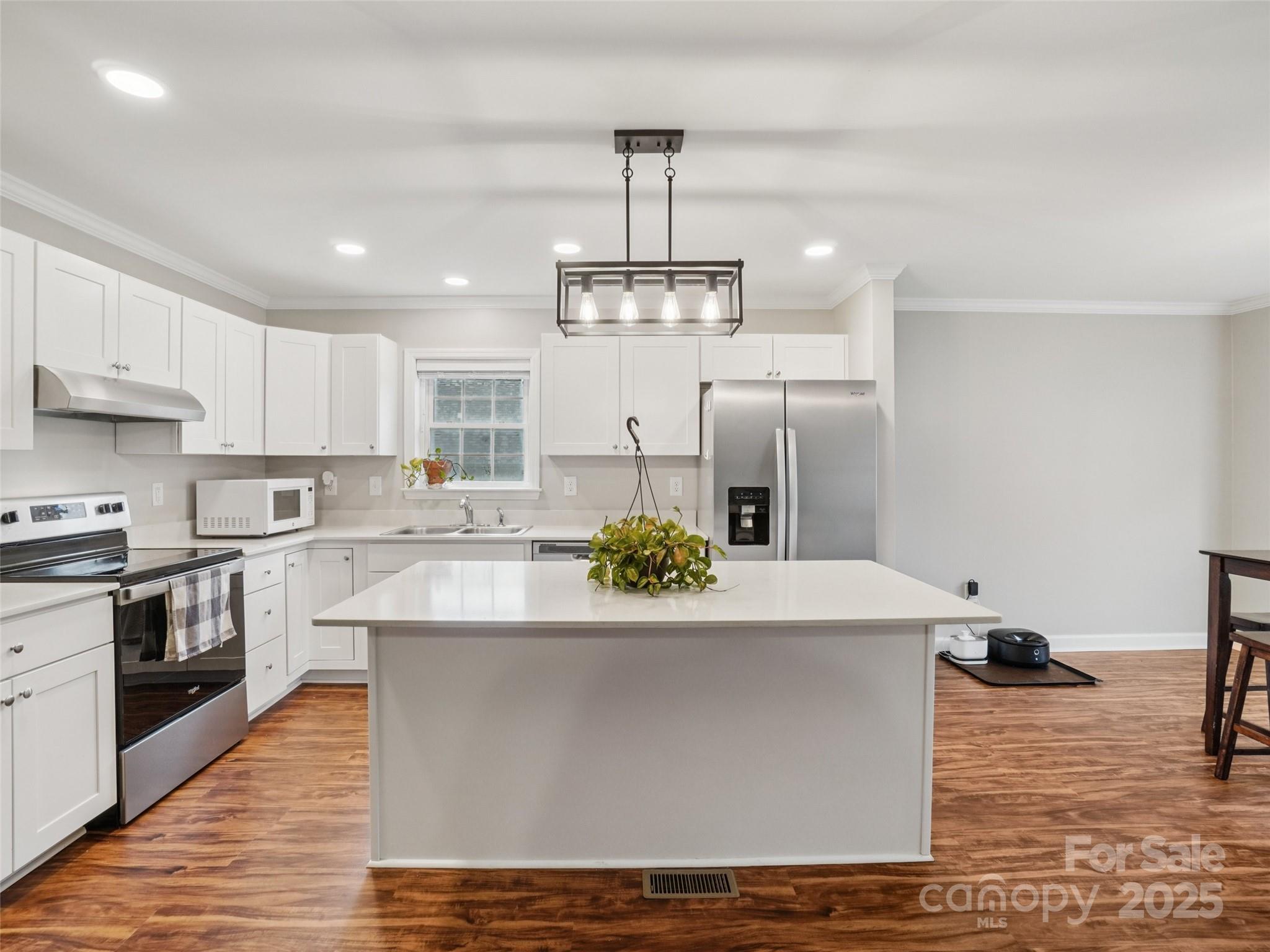 32 Lewis Street Canton, NC 28716 - Photo 4 of 27 a large kitchen with granite countertop a stove and white cabinets