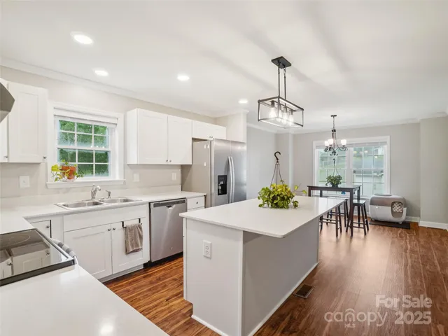 a large white kitchen with a lot of counter space