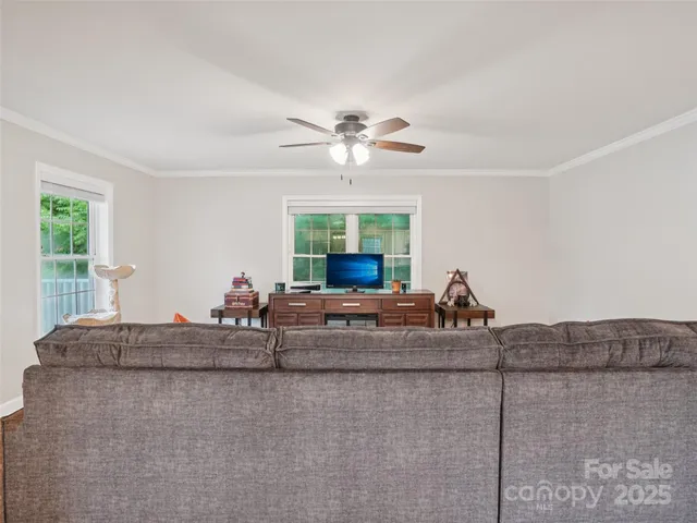a living room with furniture and a chandelier