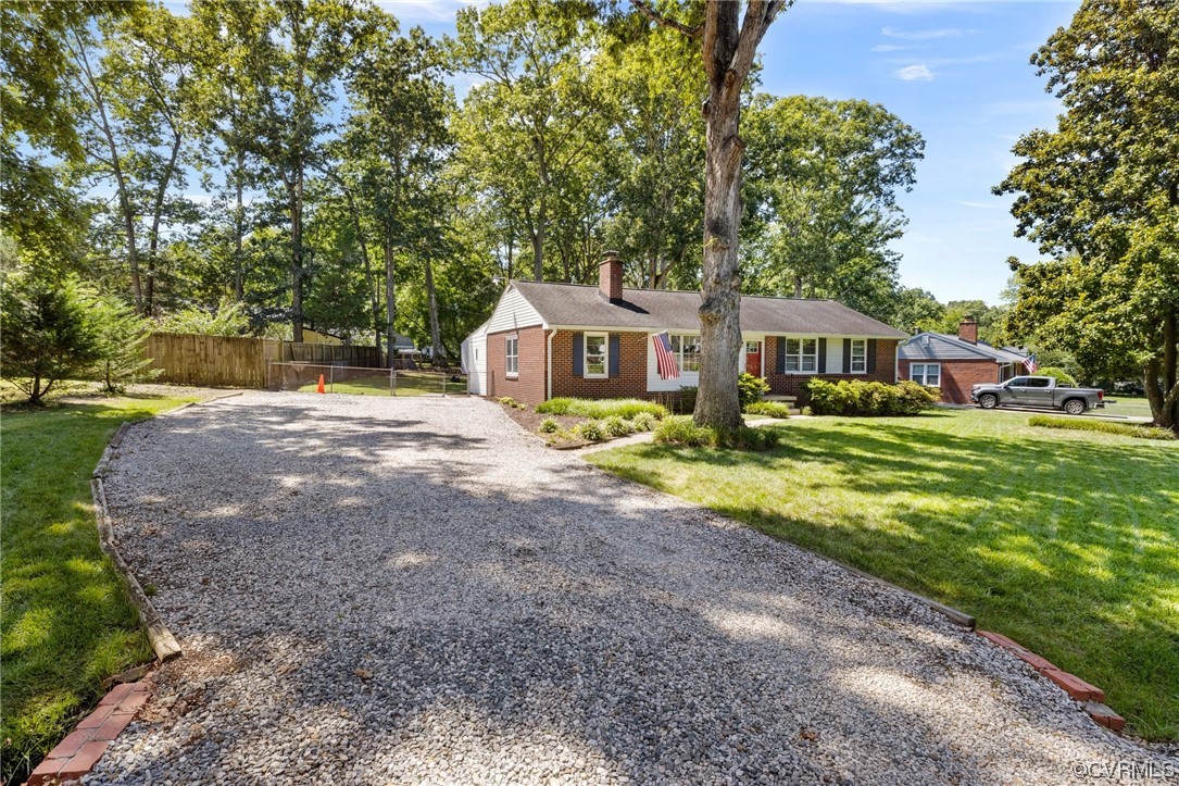 9303 Edson Road Henrico, VA 23229 - Photo 3 of 20 a front view of a house with garden and trees