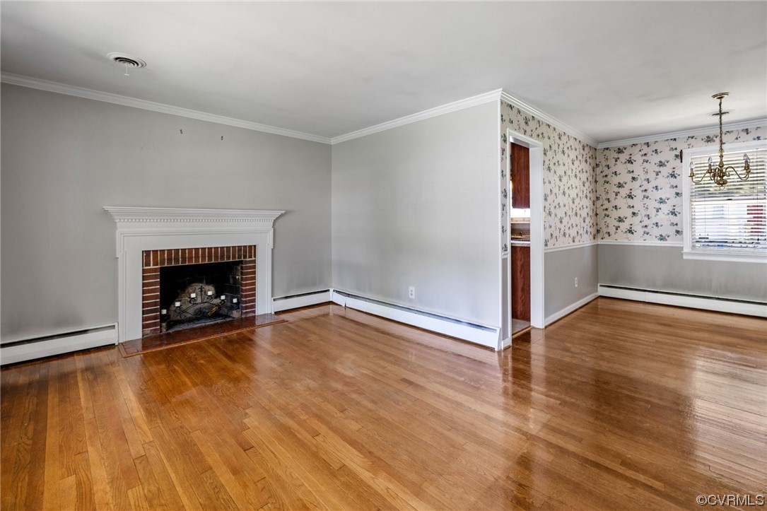 9303 Edson Road Henrico, VA 23229 - Photo 4 of 20 an empty room with wooden floor fireplace and windows