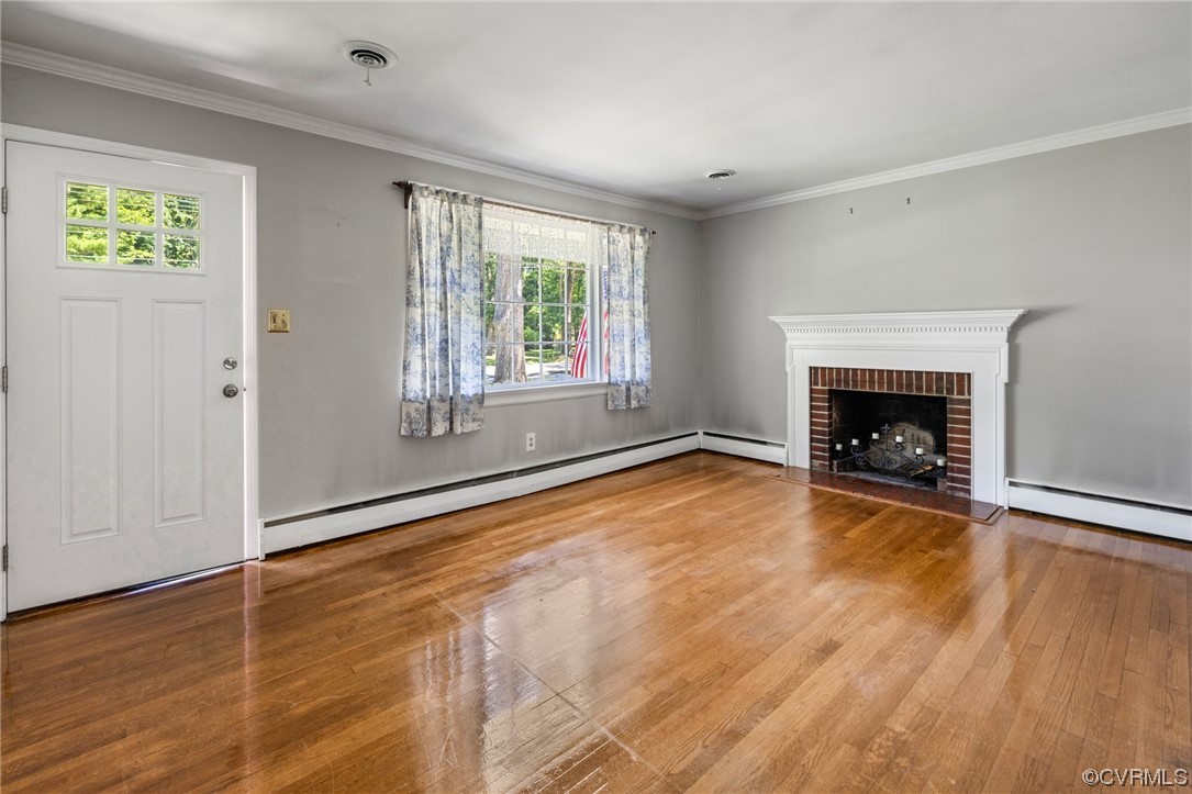 9303 Edson Road Henrico, VA 23229 - Photo 5 of 20 an empty room with wooden floor fireplace and windows