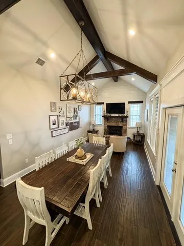 a dinning room with furniture and wooden floor