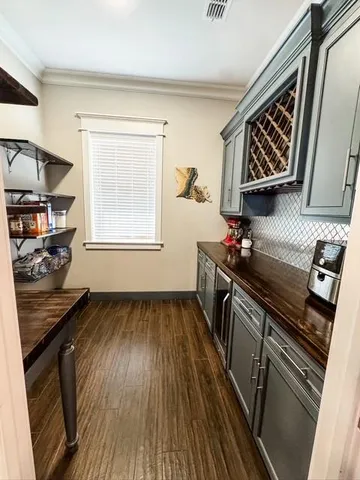 a kitchen with wooden floors and a stove