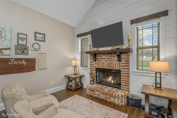 a living room with furniture and a fireplace