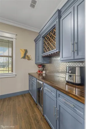 a kitchen with stainless steel appliances granite countertop a sink and wooden cabinets