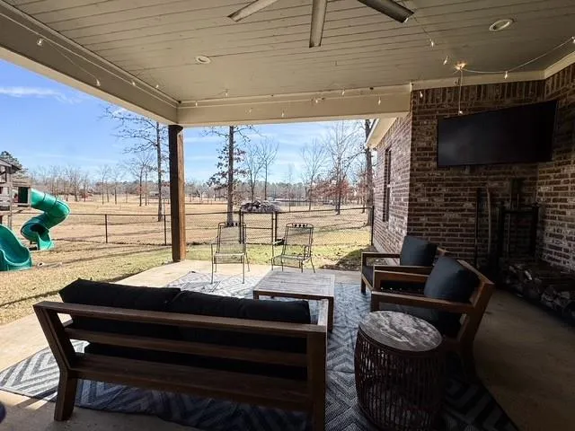 a living room with furniture and a floor to ceiling window