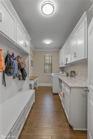 a kitchen with white cabinets and sink