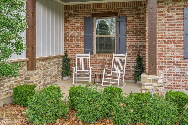 a view of house with backyard and a garden