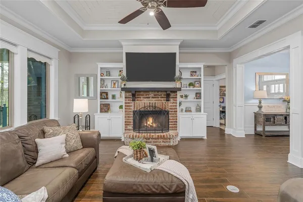 a living room with furniture fireplace and flat screen tv