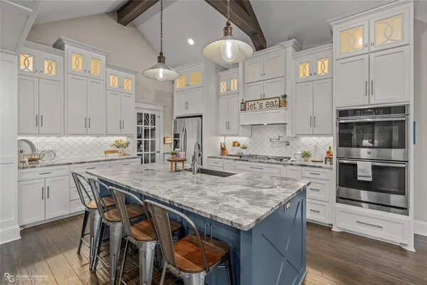 a kitchen with stainless steel appliances granite countertop a stove refrigerator and cabinets