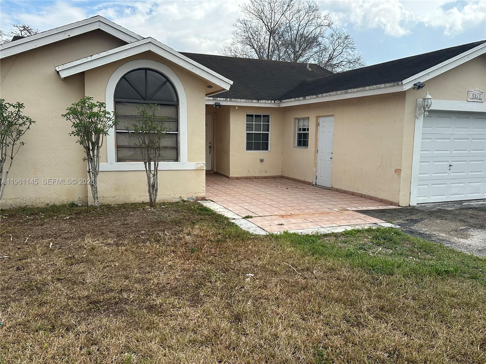 5861 Southwest 152nd Court Miami, FL 33193 - Photo 2 of 26 a front view of a house with a yard