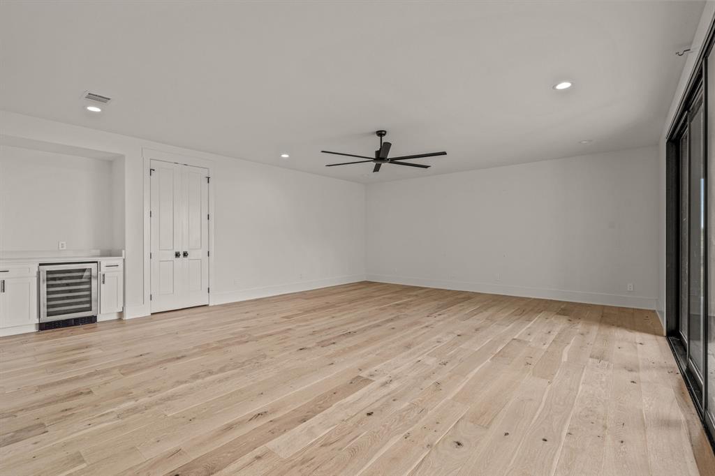 227 High View Trail Aledo, TX 76008 - Photo 24 of 39 First floor family room with a dry bar, mini fridge closet, and sliding glass doors to back patio