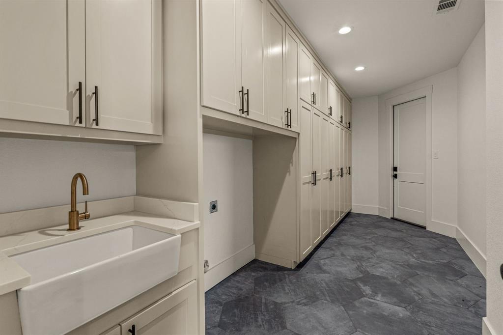 227 High View Trail Aledo, TX 76008 - Photo 26 of 39 Laundry room with a sink and floor to ceiling cabinets.