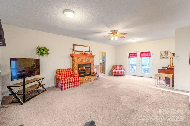a view of a livingroom with furniture and a fan