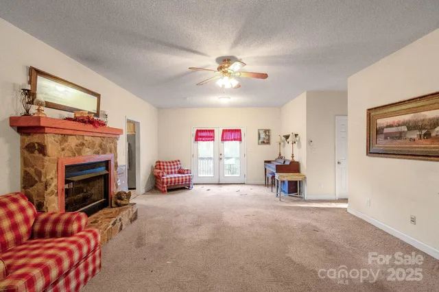 a living room with furniture and a baby crib