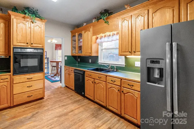 a kitchen with a sink cabinets and a large window
