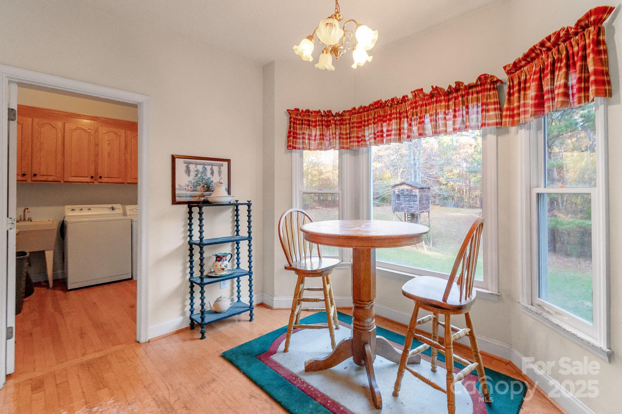 2775 State Rd S-29-285 Lancaster, SC 29720 - Photo 29 of 48 a dining room with furniture a chandelier and wooden floor