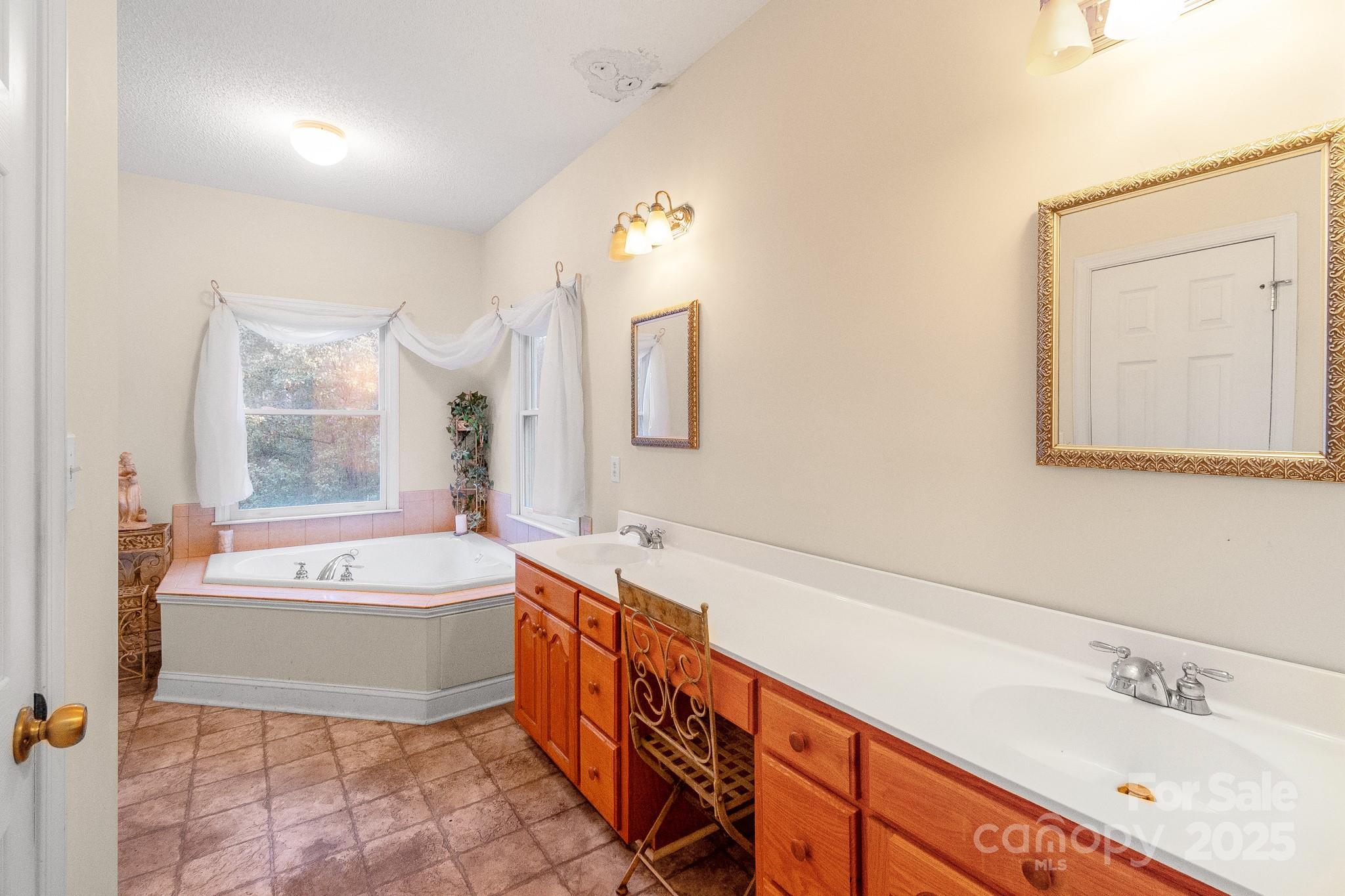 2775 State Rd S-29-285 Lancaster, SC 29720 - Photo 35 of 48 a spacious bathroom with a tub sink and mirror