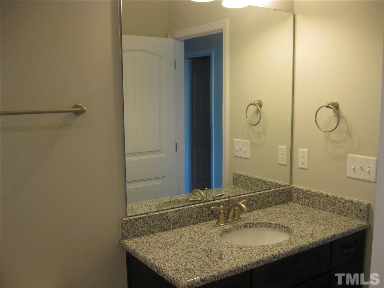 8013 Creech Road Middlesex, NC 27557 - Photo 10 of 11 a bathroom with a granite countertop sink and a mirror