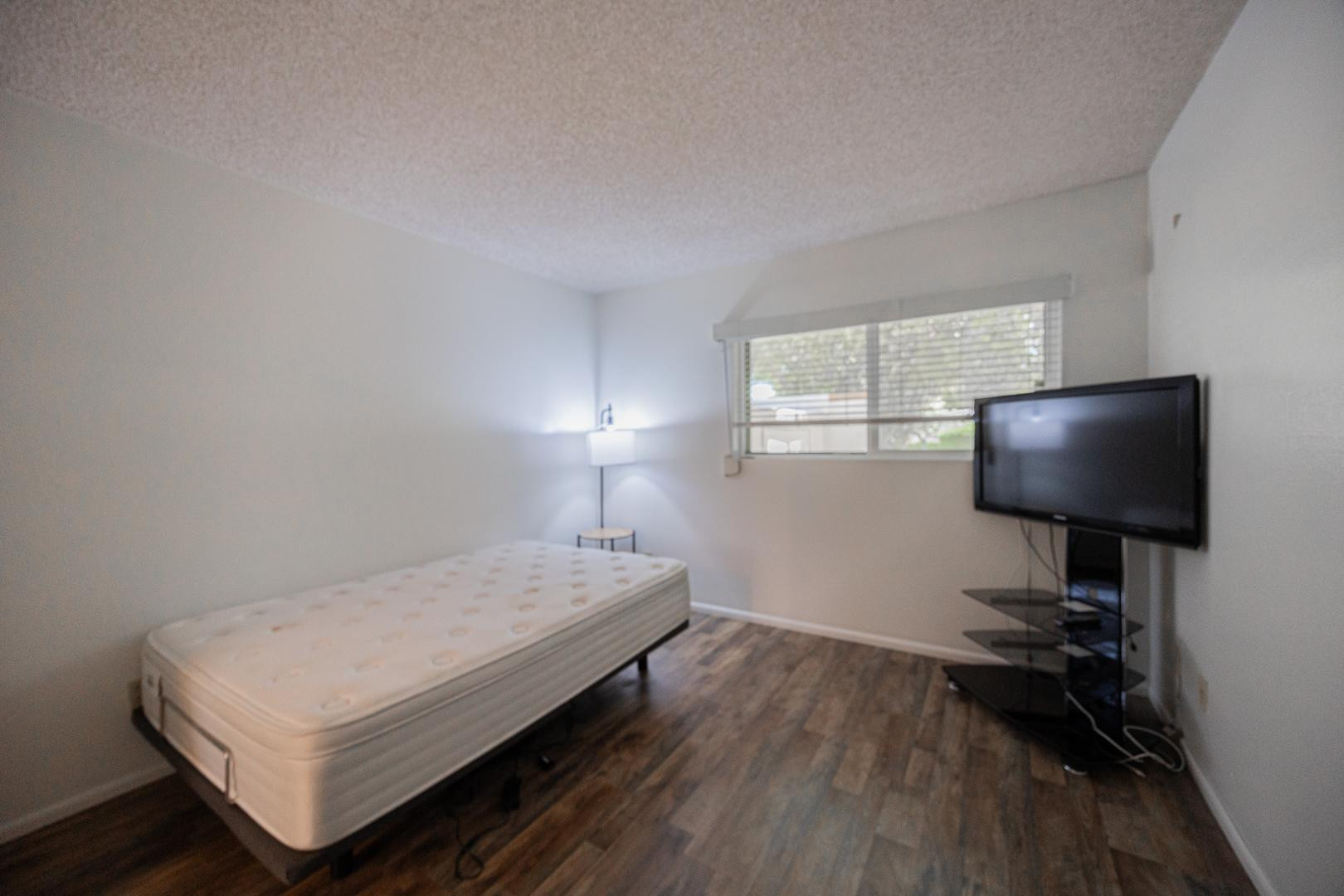 609 South Power Road, Unit 338 Mesa, AZ 85206 - Photo 17 of 24 a bedroom with a bed and a flat screen tv