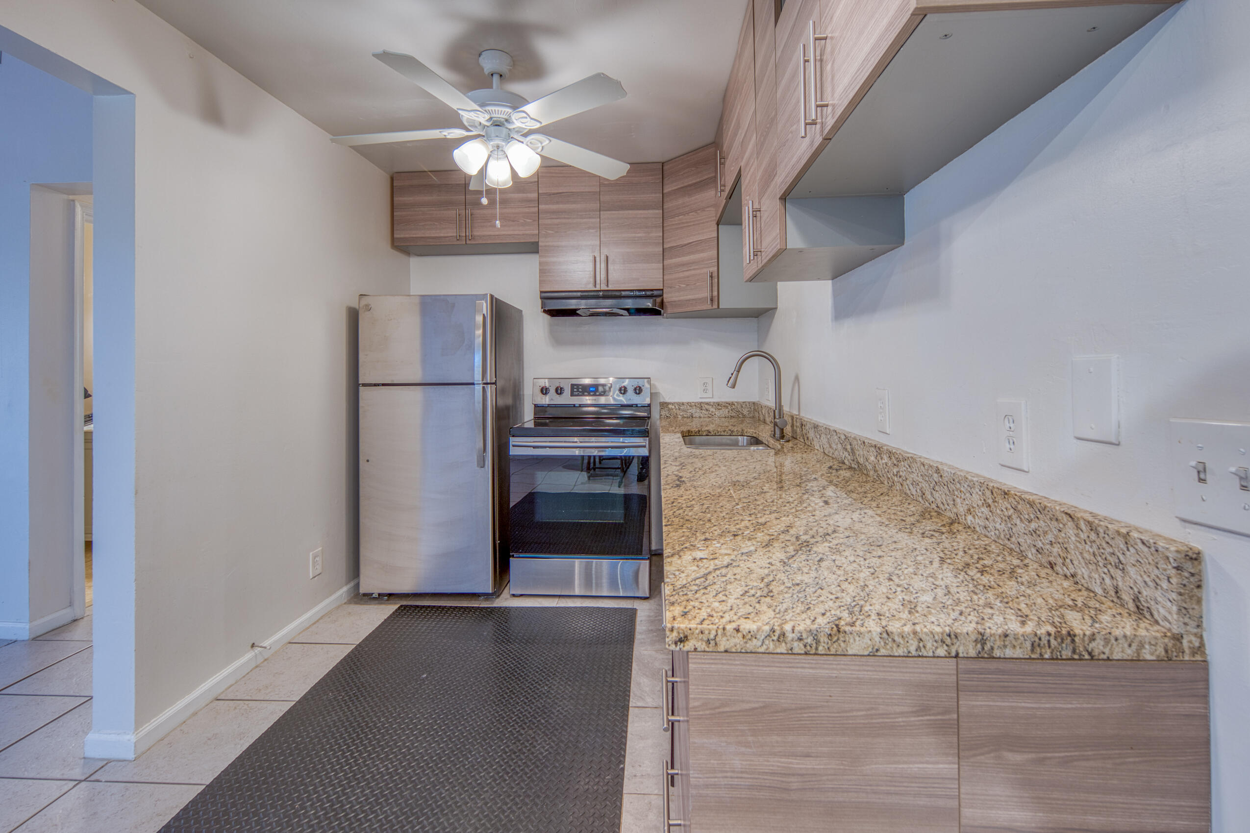 809 North Federal Highway, Unit 3 Lake Worth Beach, FL 33460 - Photo 11 of 31 a kitchen with granite countertop a refrigerator oven a sink and dishwasher
