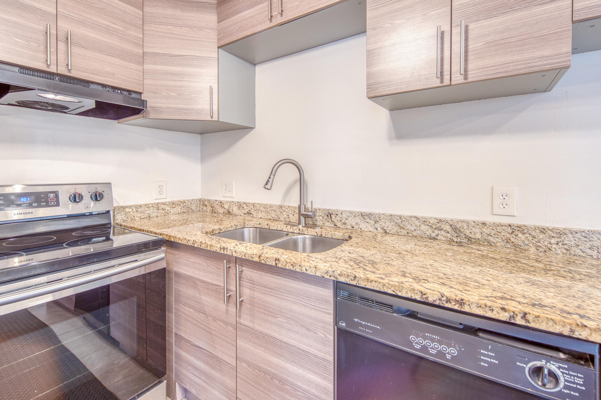 809 North Federal Highway, Unit 3 Lake Worth Beach, FL 33460 - Photo 12 of 31 a kitchen with granite countertop a sink and cabinets