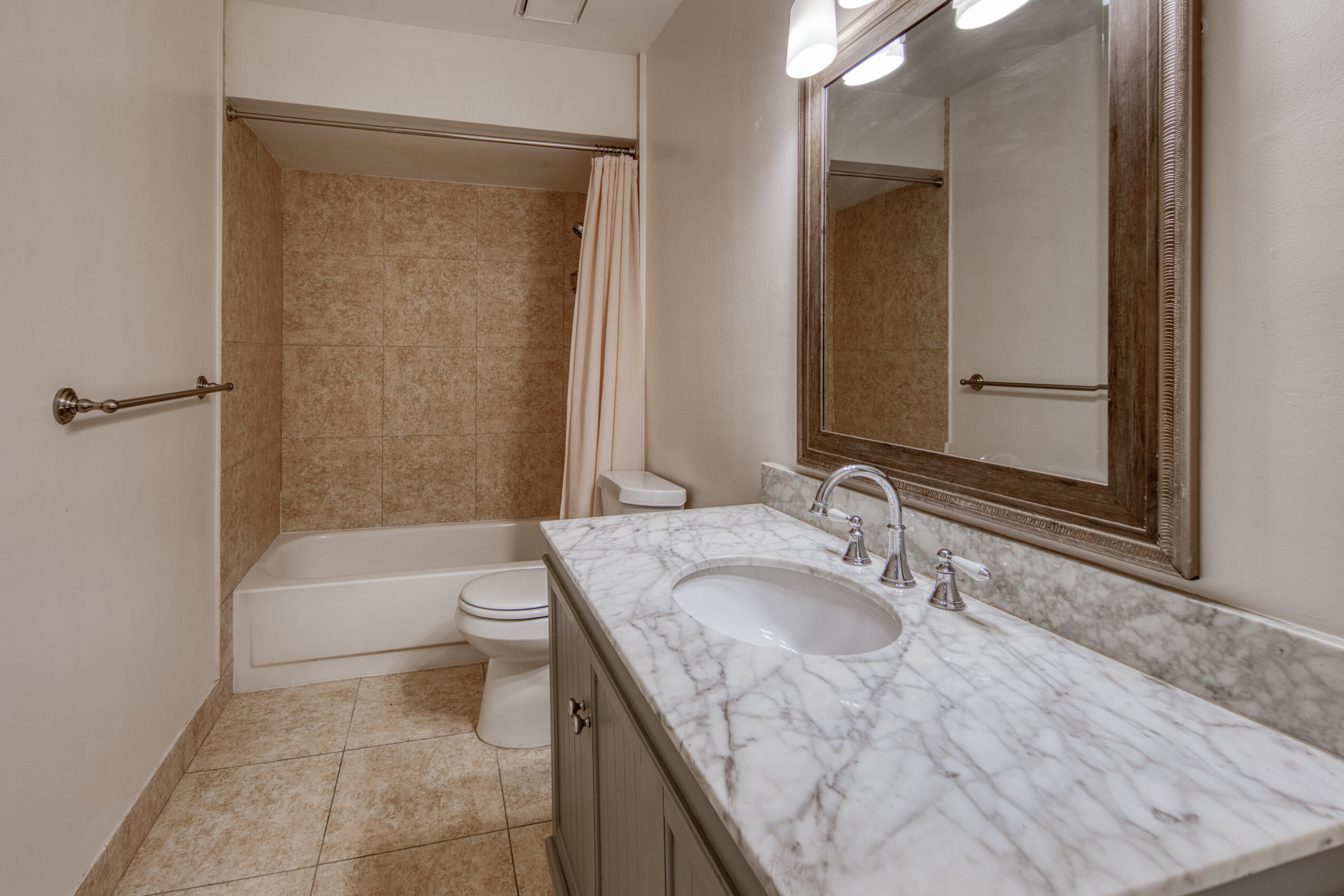809 North Federal Highway, Unit 3 Lake Worth Beach, FL 33460 - Photo 22 of 31 a bathroom with a granite countertop sink a toilet and bathtub