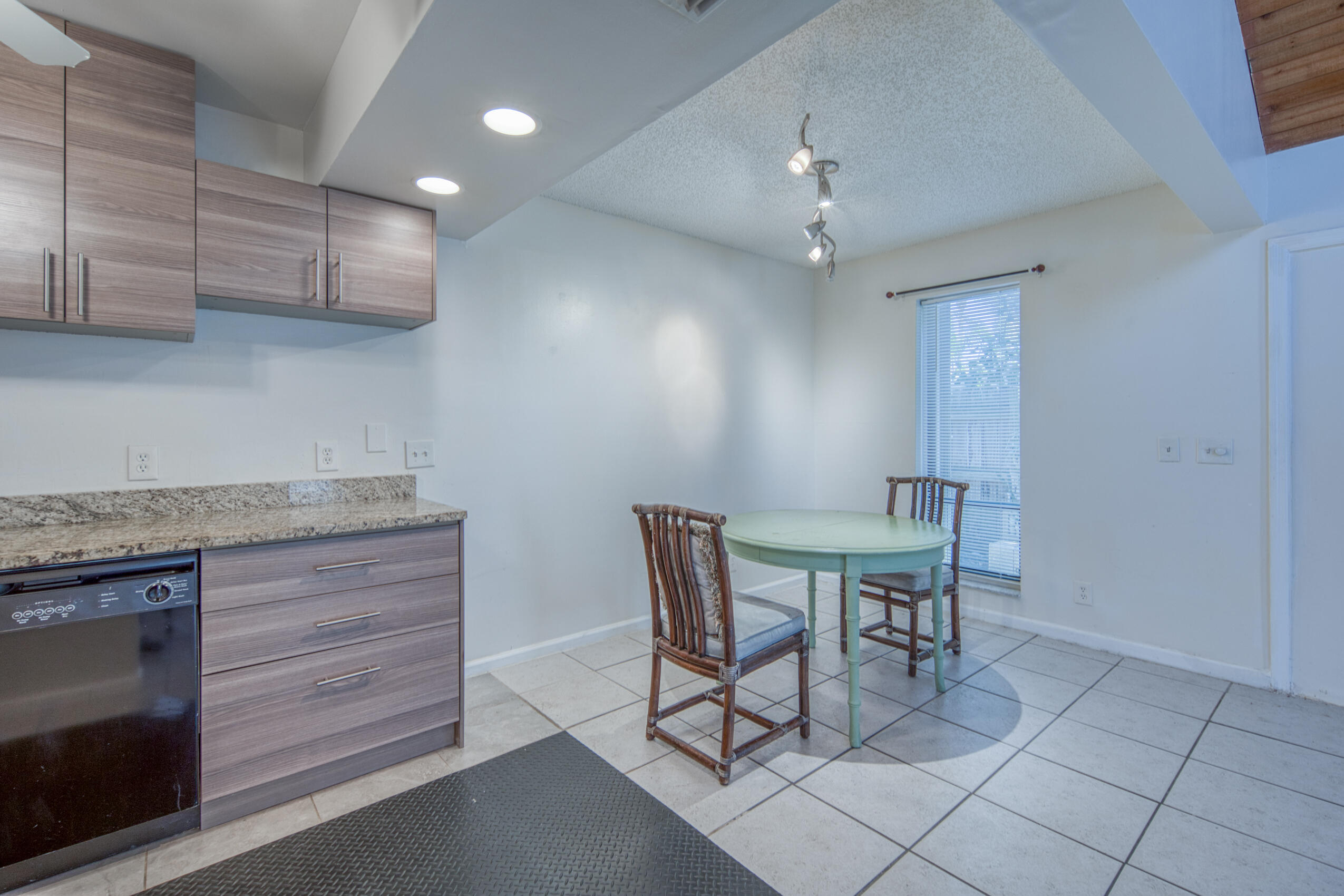 809 North Federal Highway, Unit 3 Lake Worth Beach, FL 33460 - Photo 30 of 31 a view of a kitchen with granite countertop cabinets table and chairs