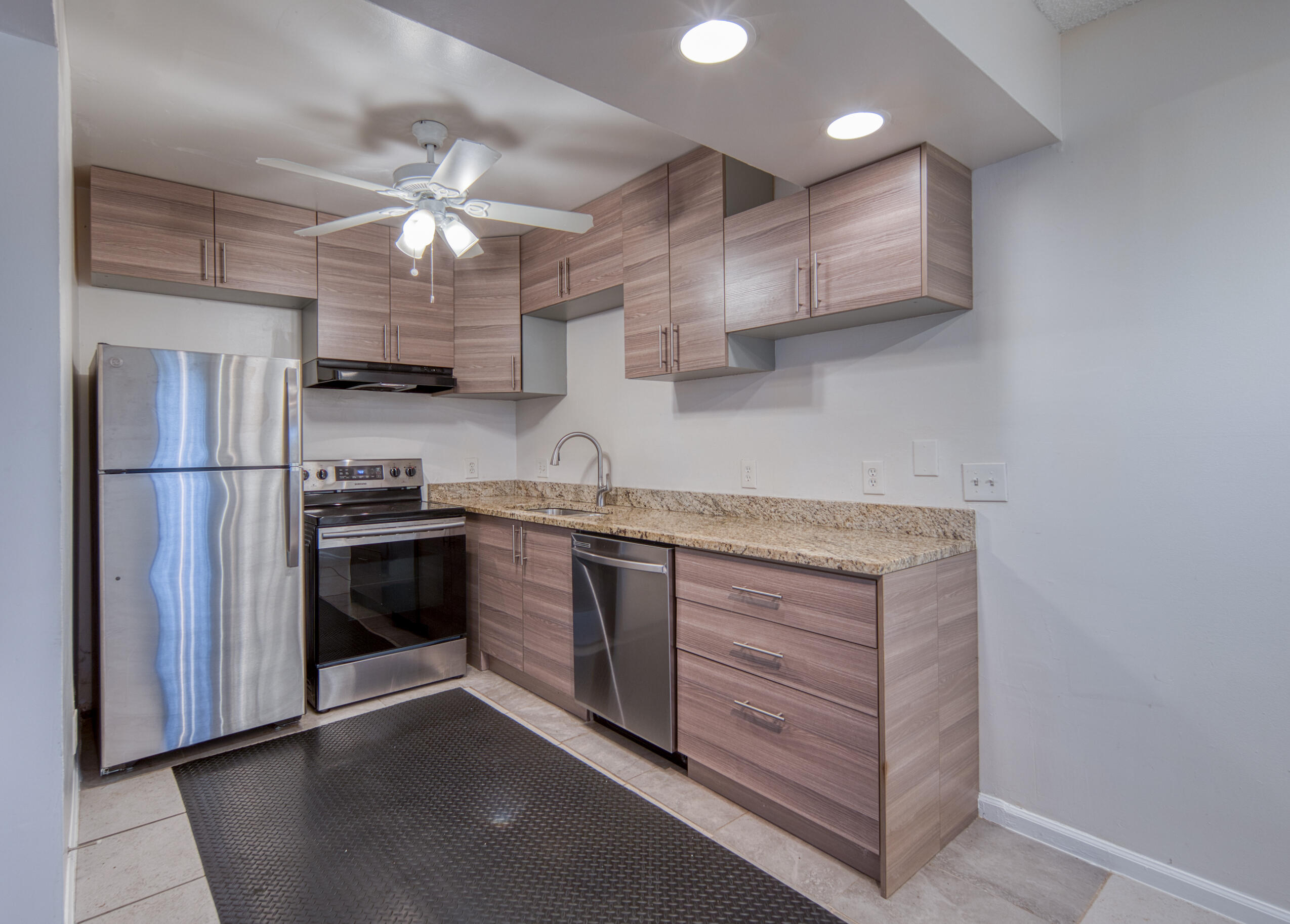 809 North Federal Highway, Unit 3 Lake Worth Beach, FL 33460 - Photo 3 of 31 a kitchen with stainless steel appliances granite countertop a sink and a refrigerator