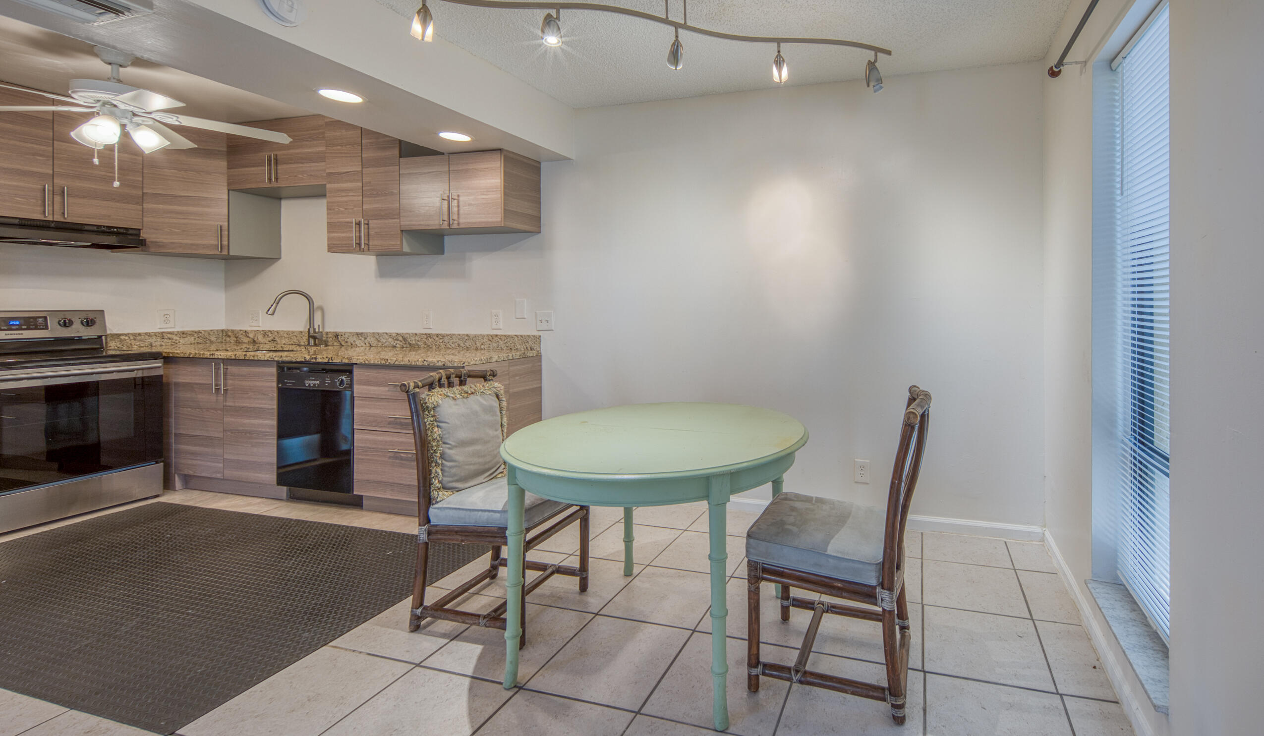 809 North Federal Highway, Unit 3 Lake Worth Beach, FL 33460 - Photo 10 of 31 a kitchen with cabinets and chairs