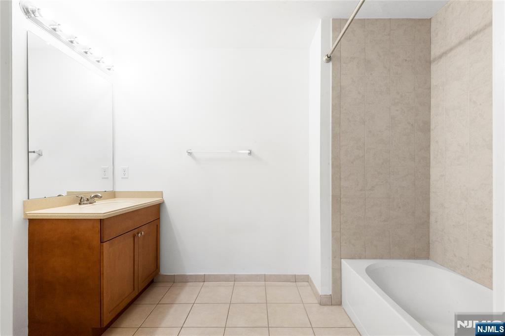 54 Polifly Road, Unit 311 Hackensack, NJ 07601 - Photo 15 of 20 a bathroom with a sink a toilet and shower
