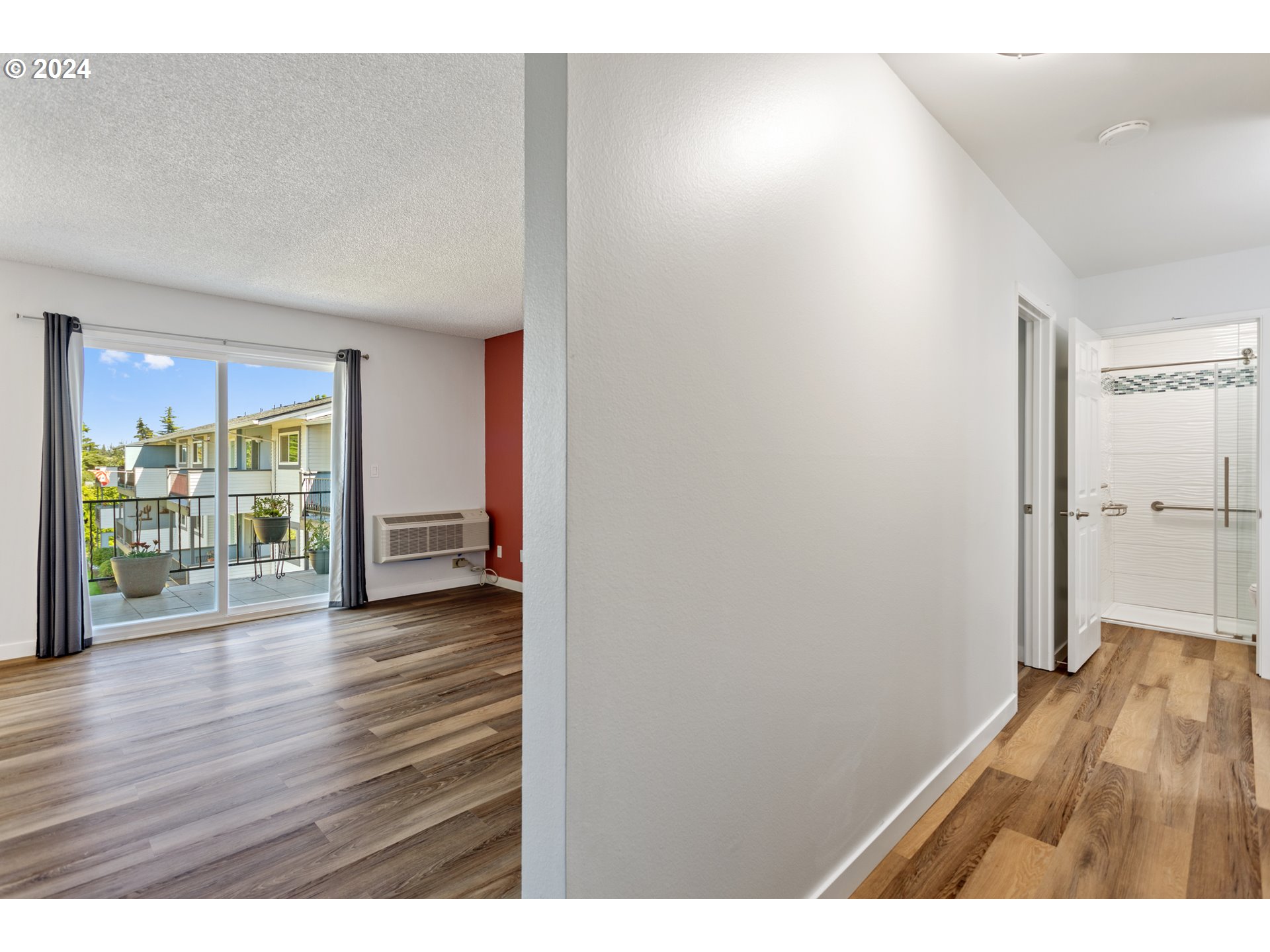950 Evergreen Road, Unit 316 Woodburn, OR 97071 - Photo 5 of 38 a view of an empty room with wooden floor and a window
